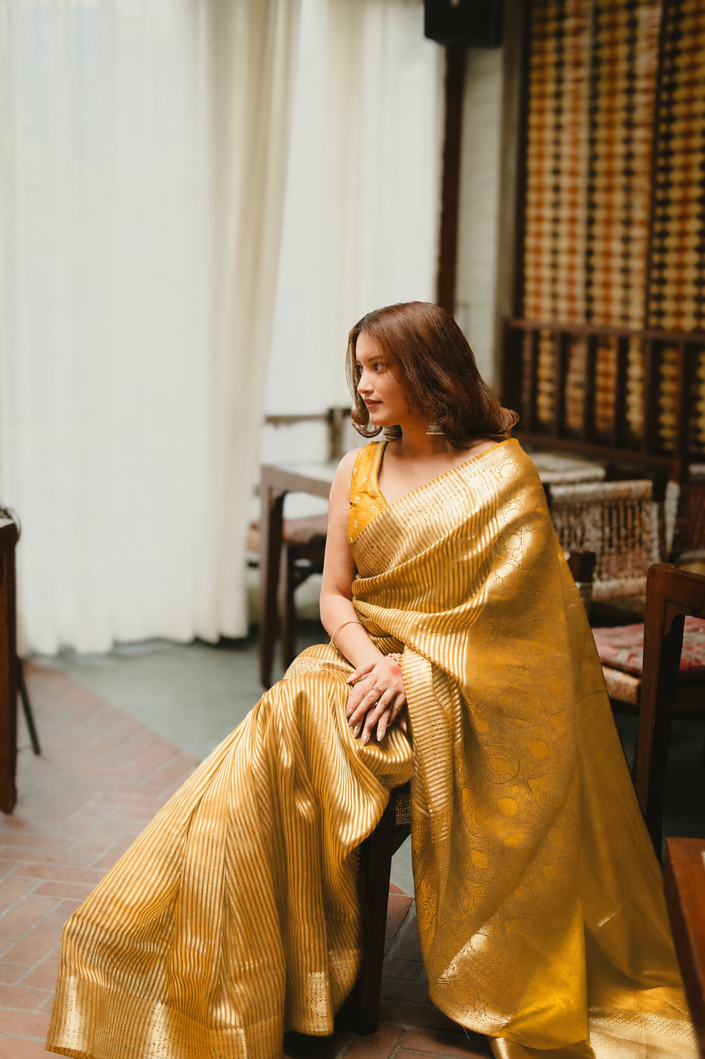 Aparajita Pitambari golden yellow striped tissue silk Banarasi saree, draped